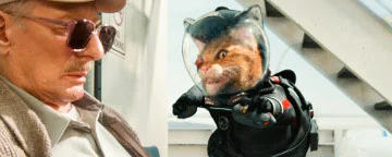 Old Man Looking At A Cat In A Space Suit