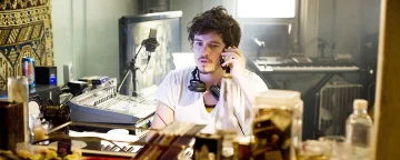 David On A Mobile Phone With Headphones Round His Neck